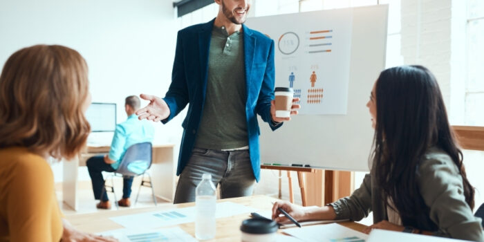 Professionals in a room having a discussion with a presentation