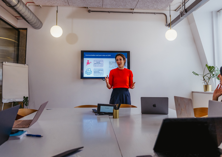 Professional speaking with calm confidence and grounded presence in a group setting