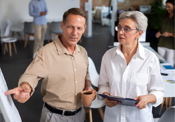 Two professionals demonstrating authentic leadership through collaborative discussion and shared decision-making