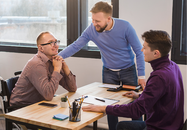 Professionals building genuine rapport through supportive, open communication in a workplace setting