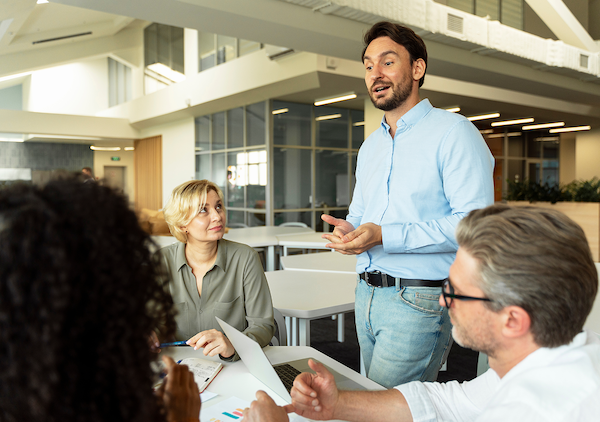 Professional demonstrating executive presence while speaking confidently with a team